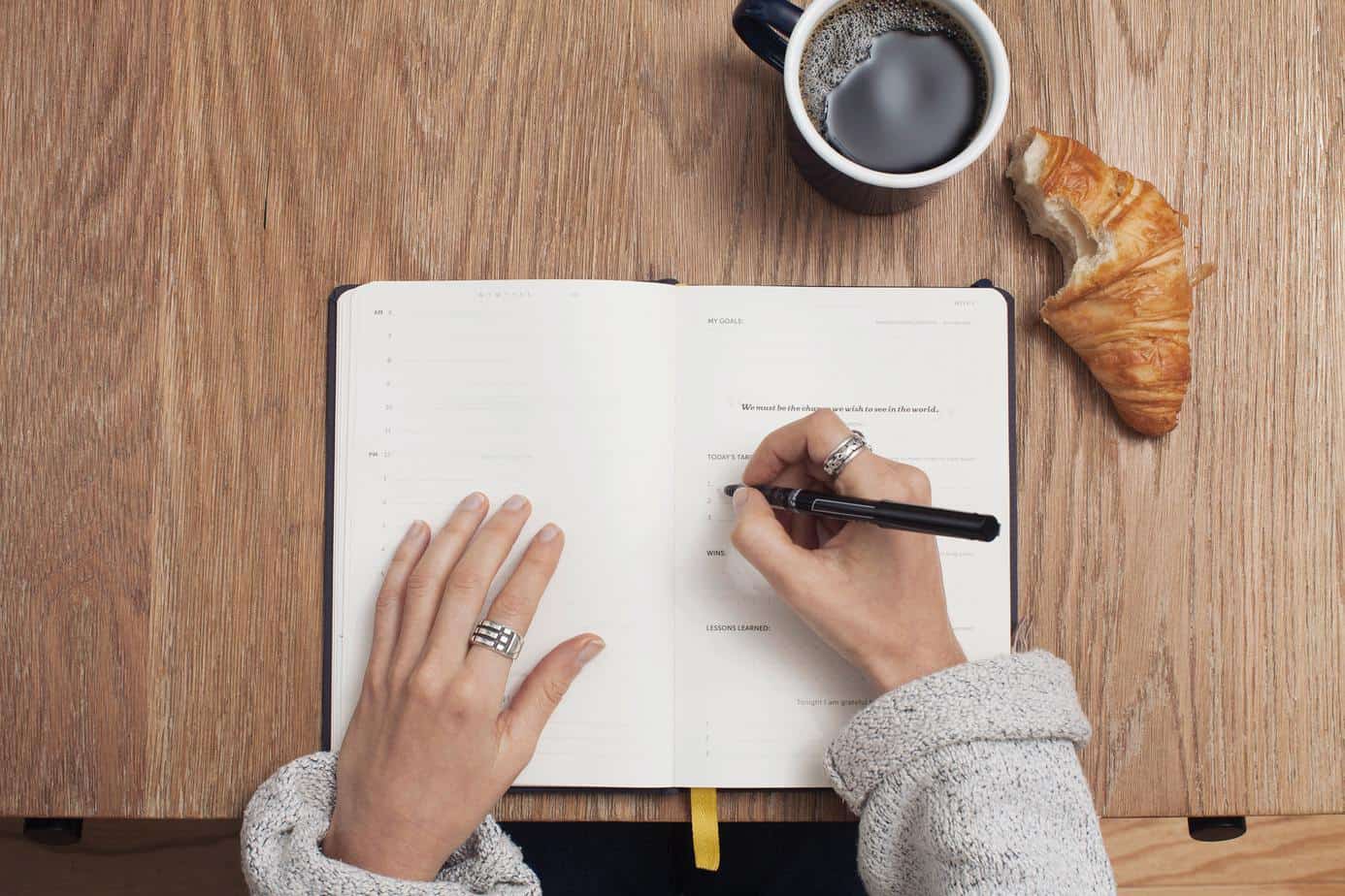 person identifying common unhealthy habits in a journal and how to change them.
