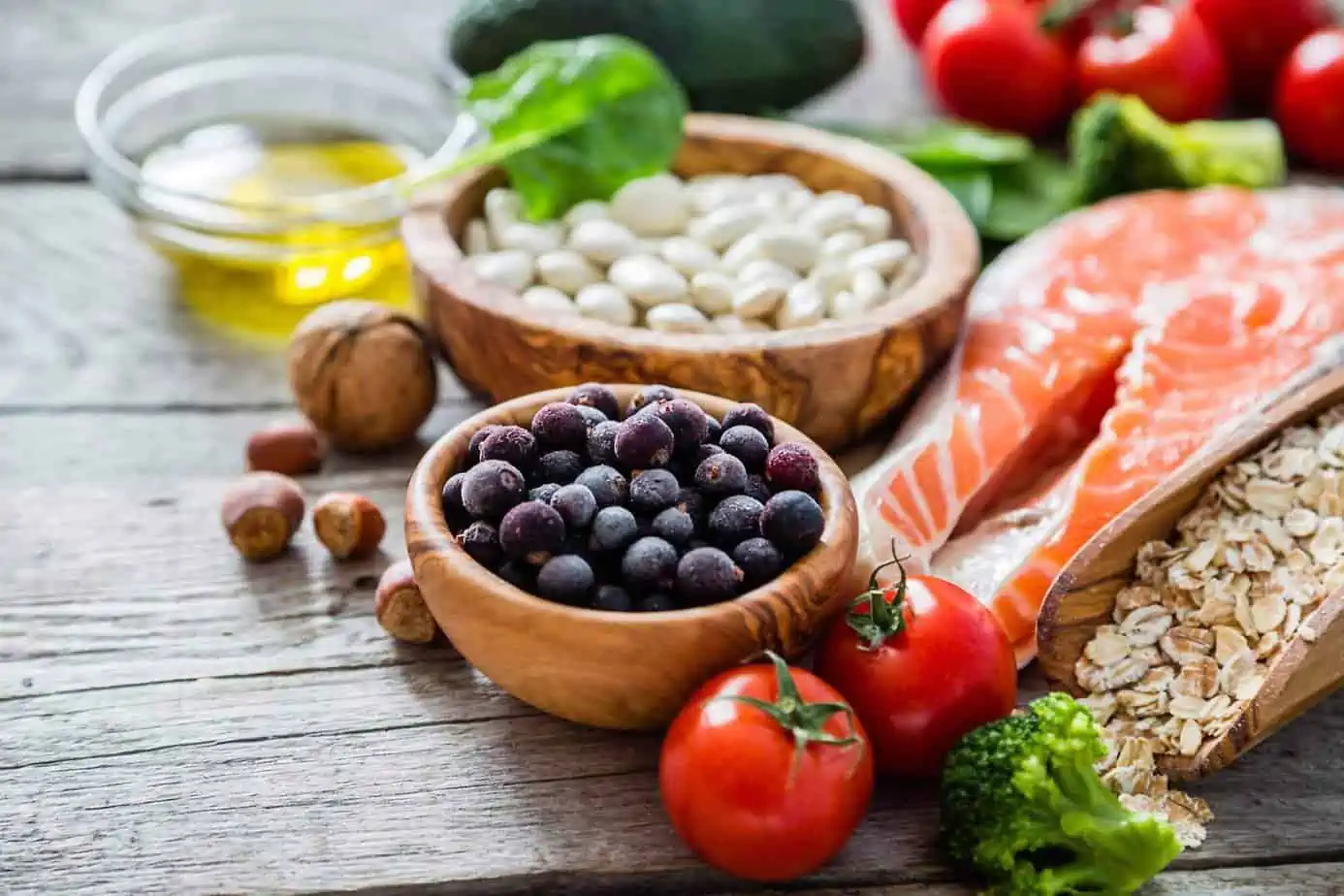 Blueberries, tomatoes, salmon, walnut, and broccoli lying on a table