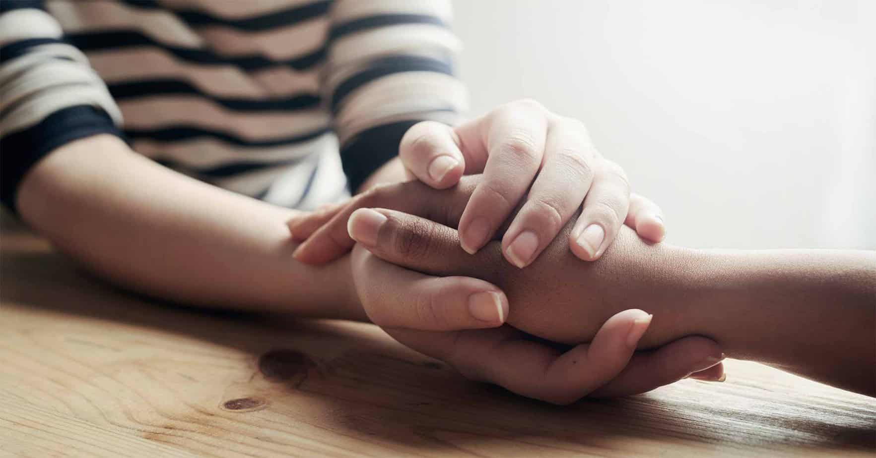 Couple holding hands in comfort