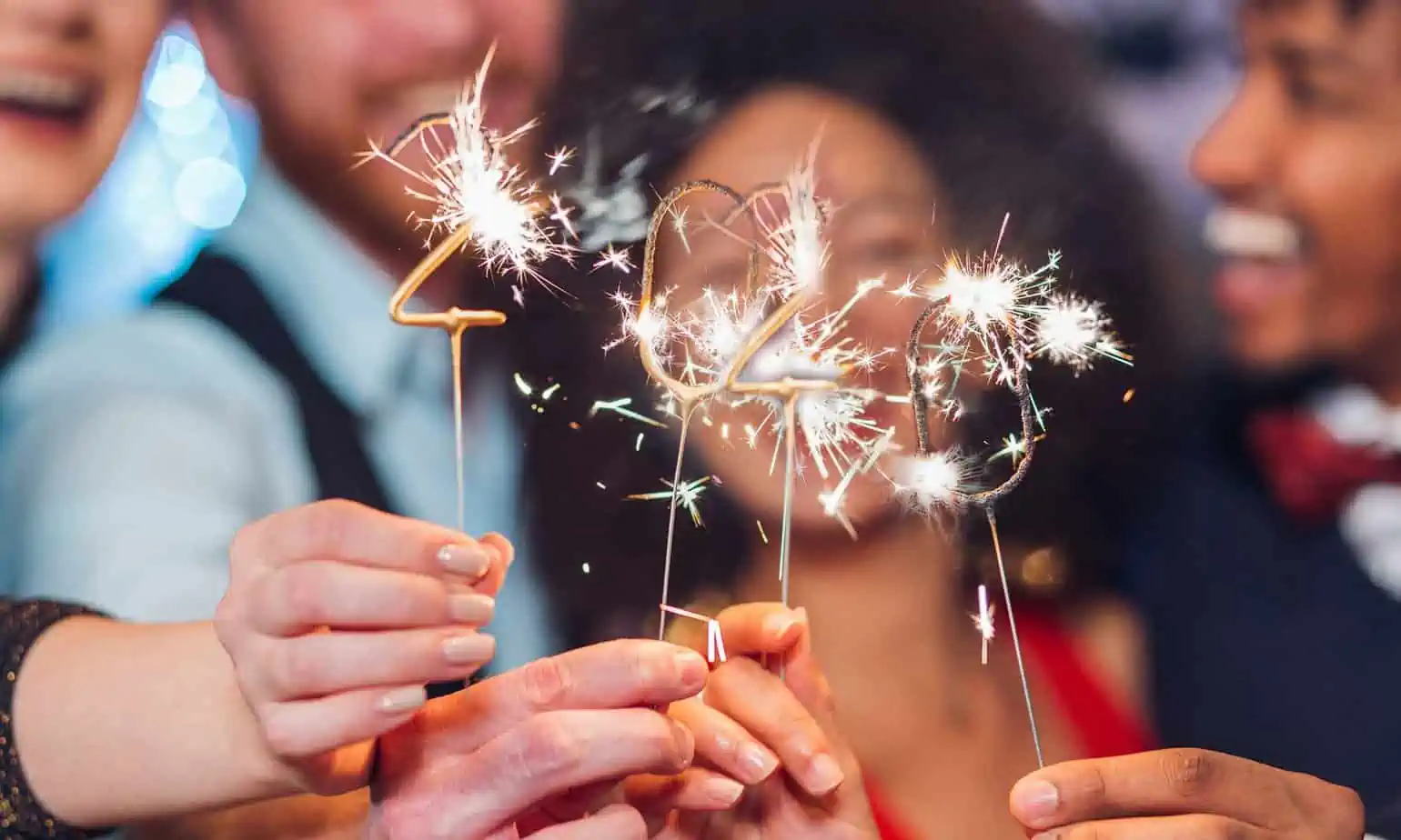 group of friends holding 2020 sparkler for new years eve