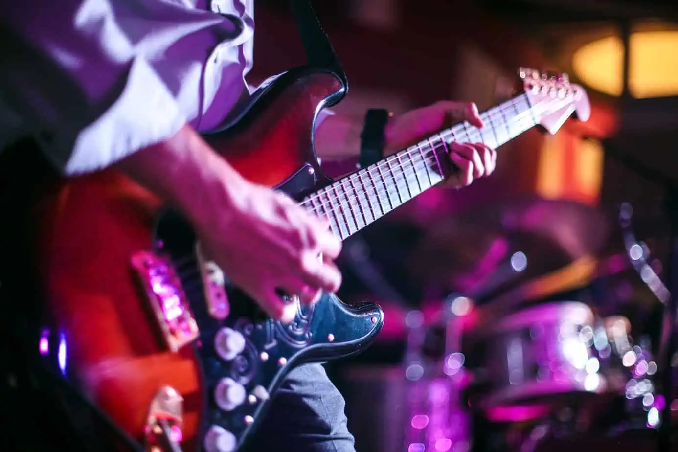 wharf rat guitarist playing in a band with a pick in his hand
