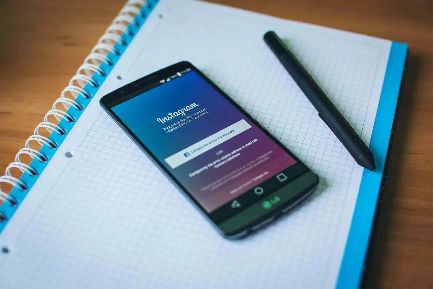 instagram app on phone on notebook