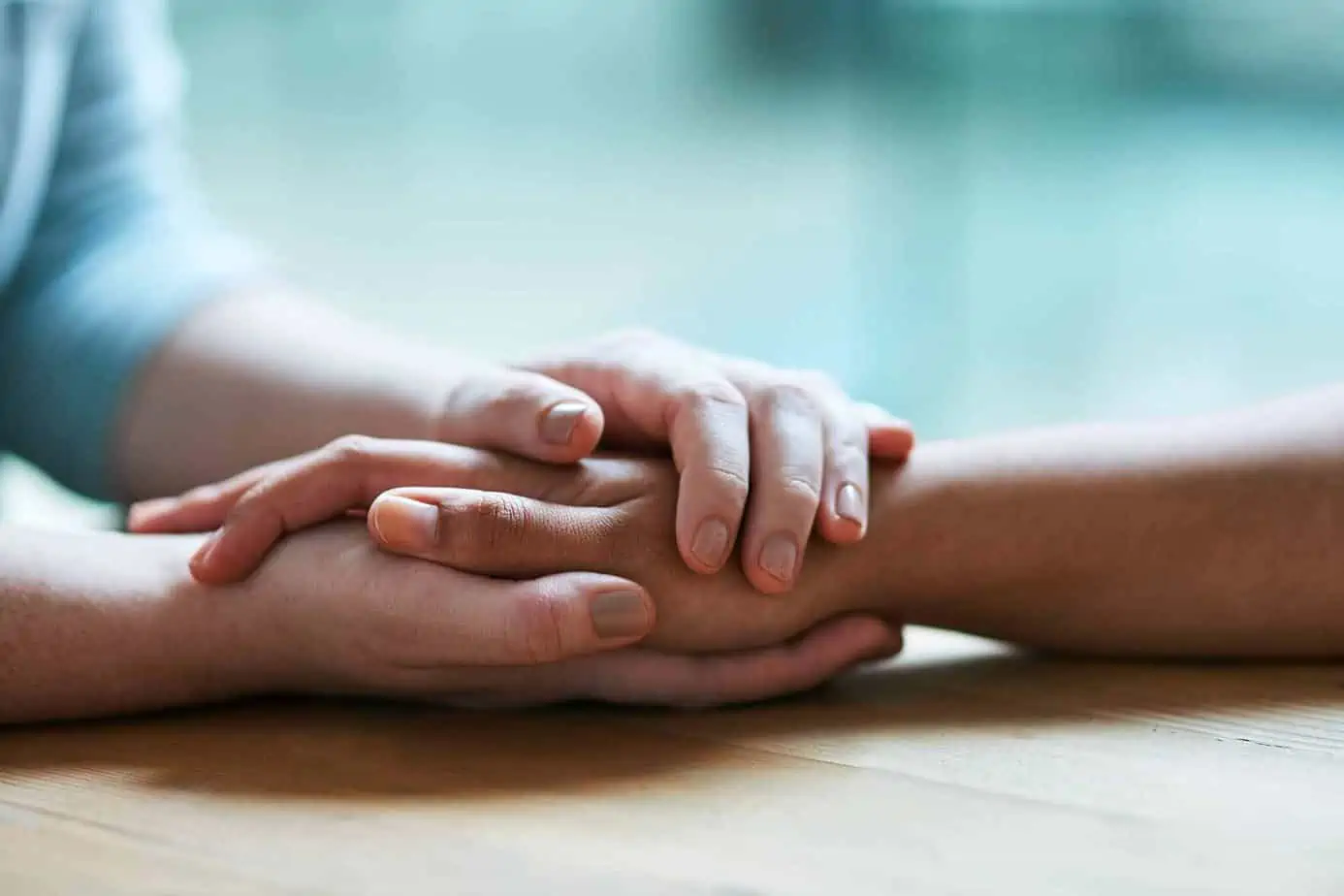 one hand holding another and being supportive during recovery
