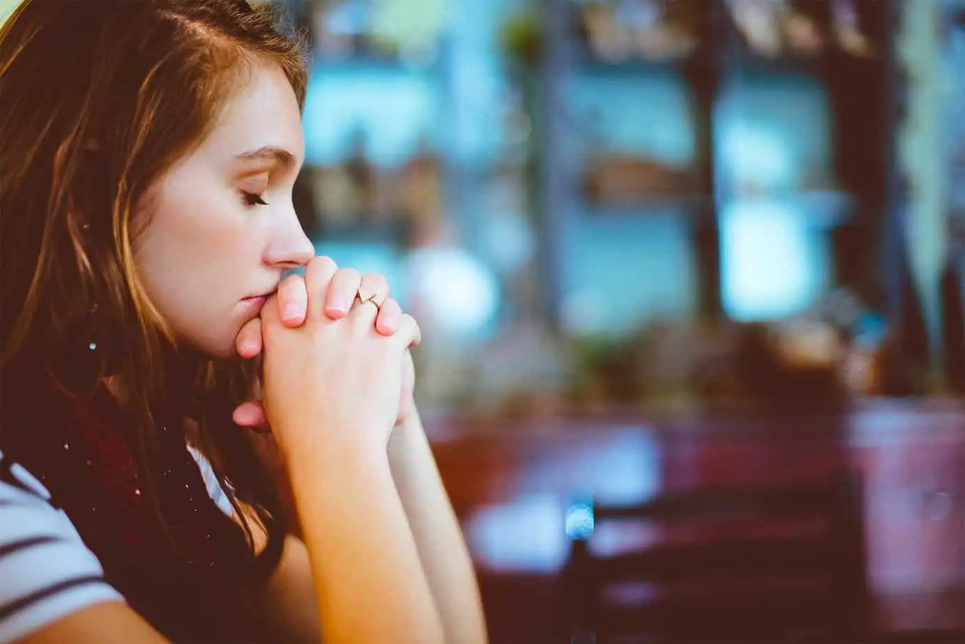 Young woman praying in solitude