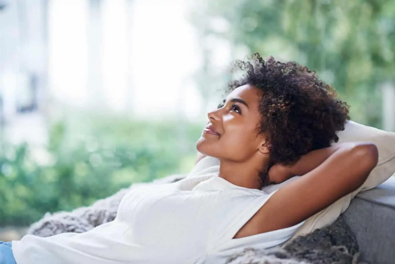 woman leaning back on chair smiling and relaxing