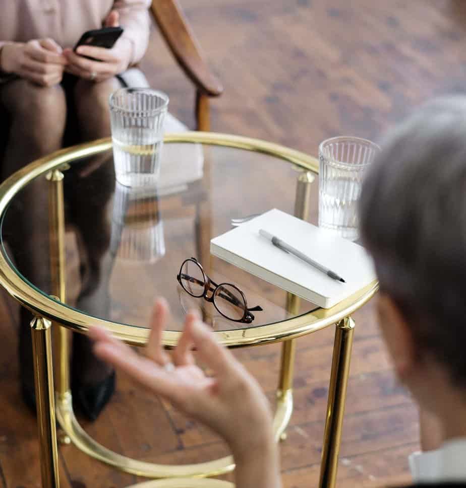Mountainside Treatment Center: A Coach / counselor and patient talking with a table between them