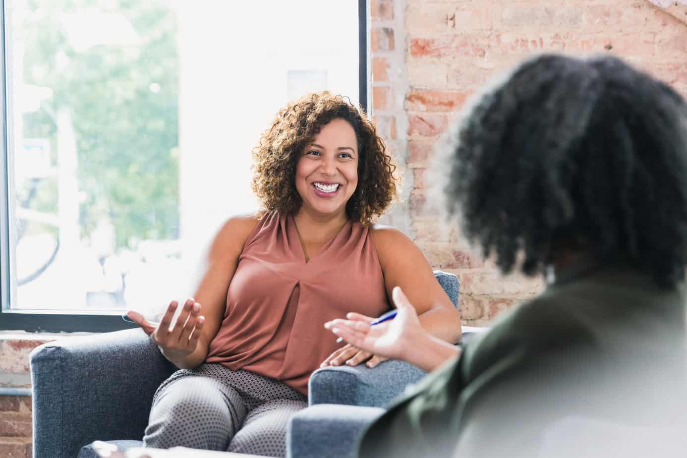 woman talks about how to find the right therapist with another woman, both seated