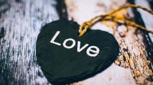 black badge labeled with the word love