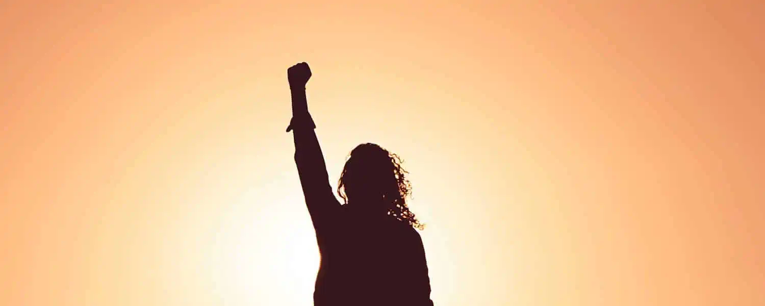 woman with fist raised in air in celebration