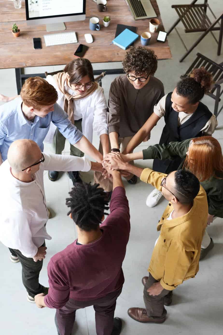 A diverse group of people supporting one another.