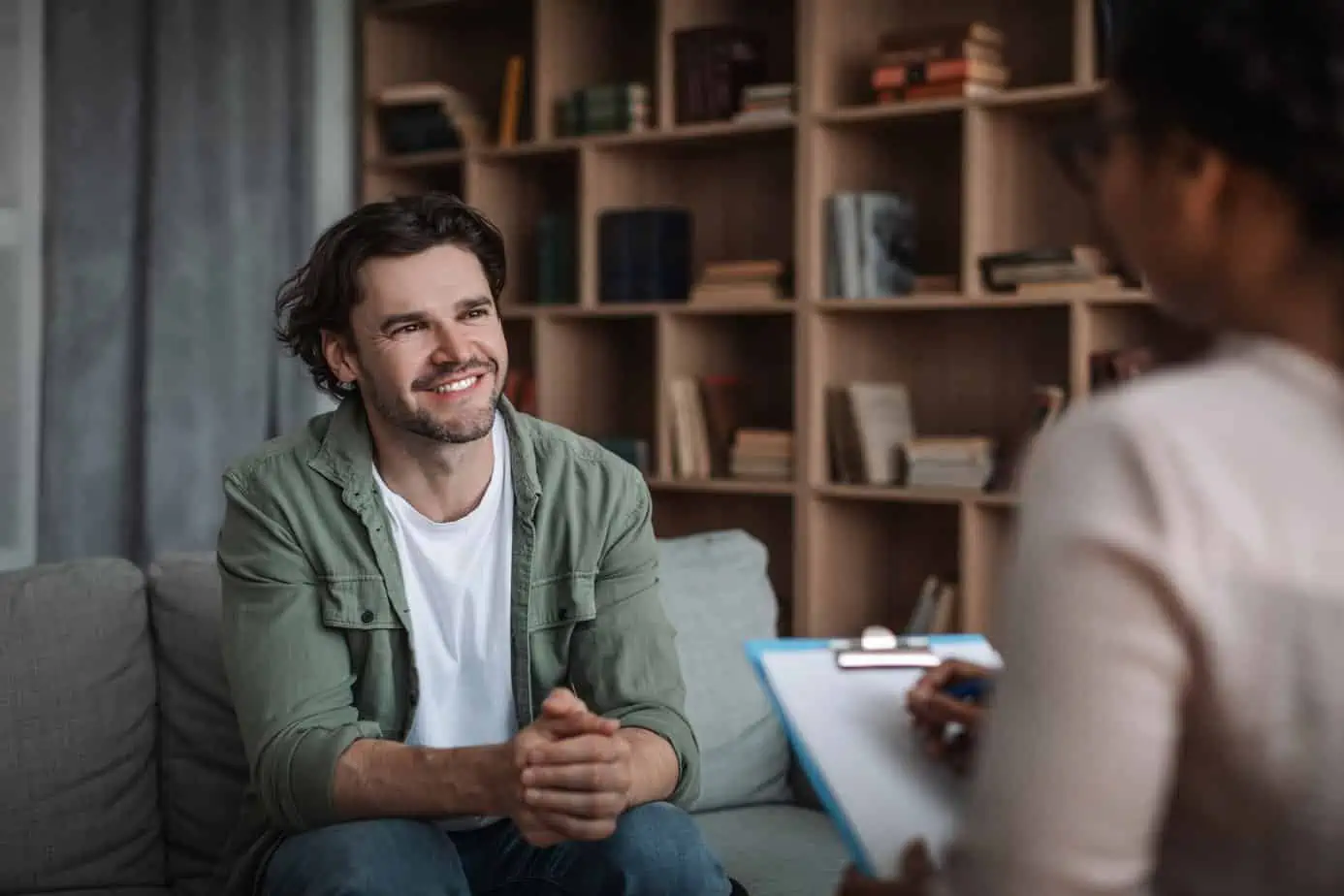 man sits in a family therapy session discussing addiction