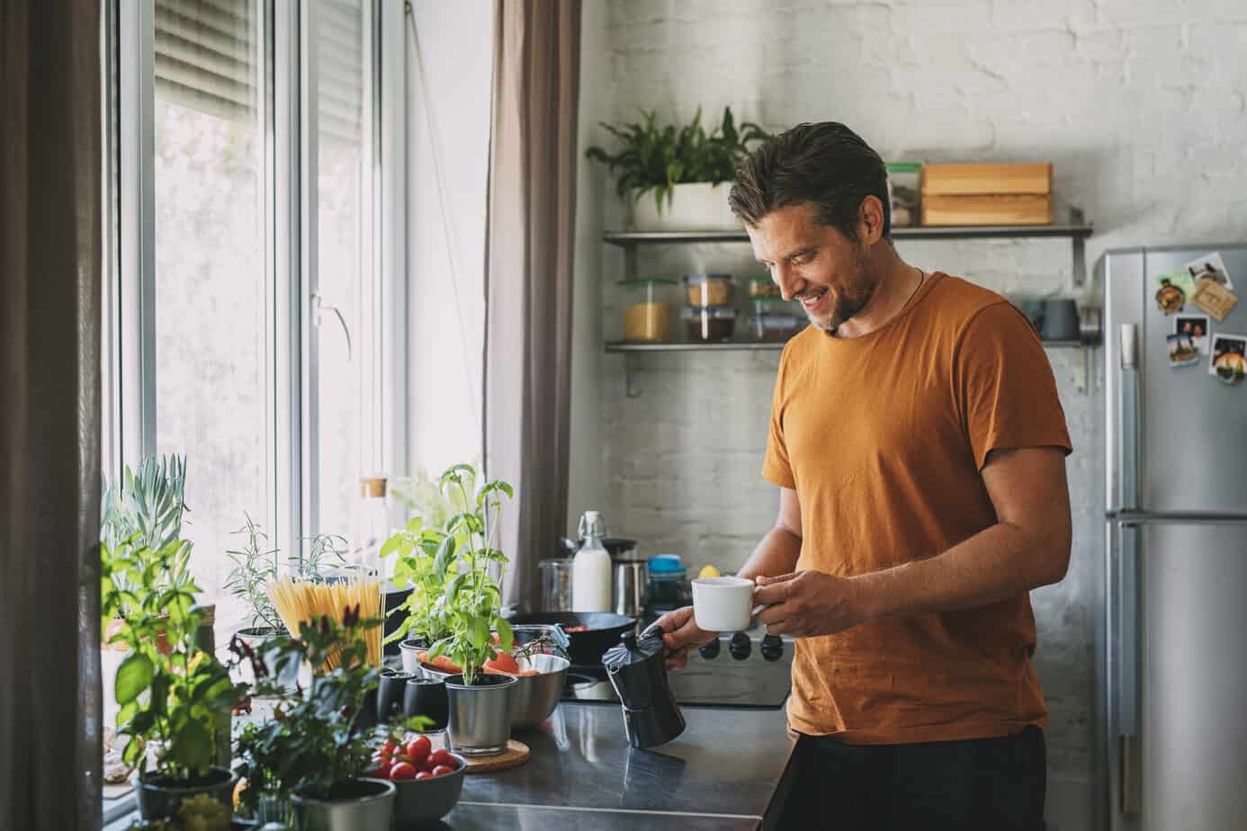 man in sobriety pouring coffee in kitchen
