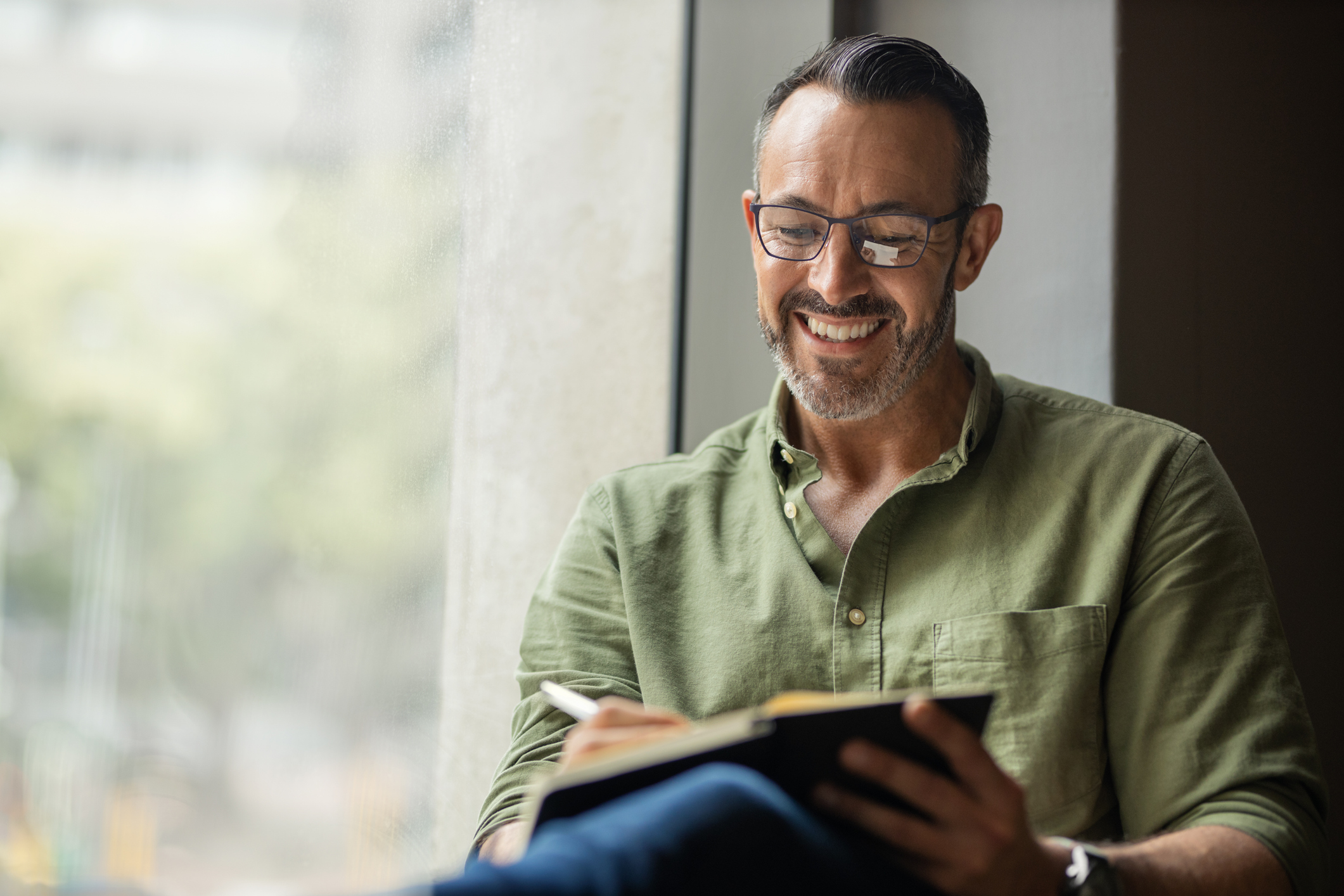 man journaling as a form a self-care for mental health