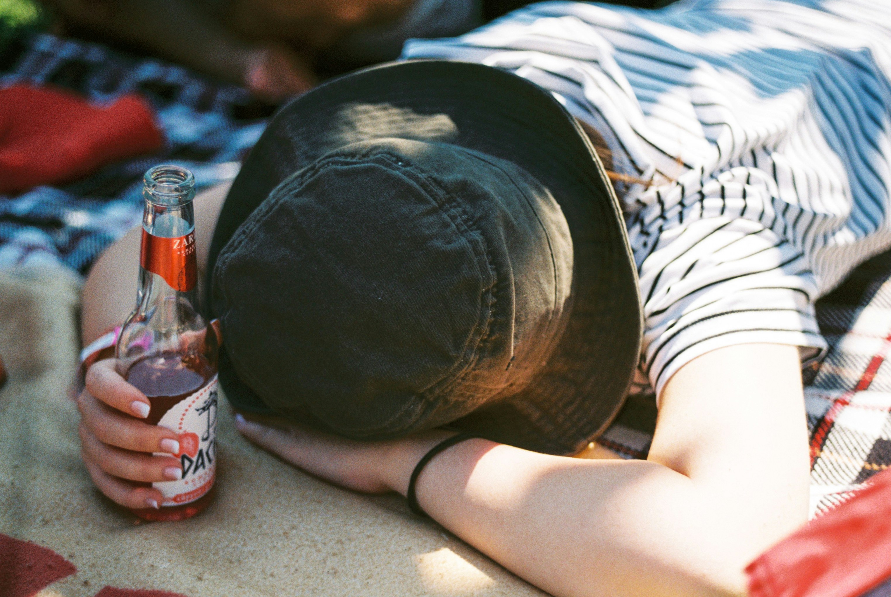 a man appears to be passed out from drinking too much alcohol