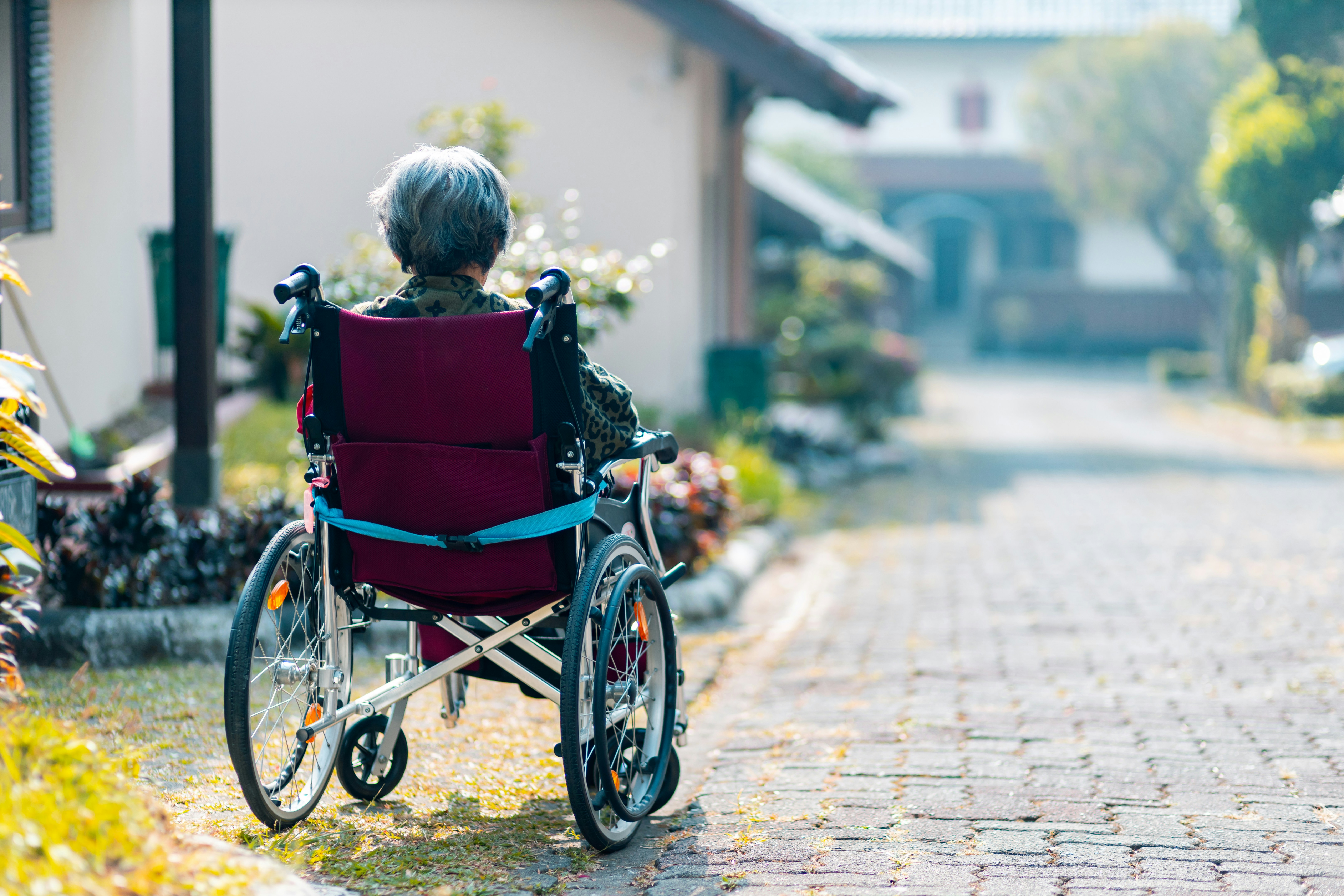 A man sits lonely in a wheelchair, perhaps suffering from dementia from alcohol abuse